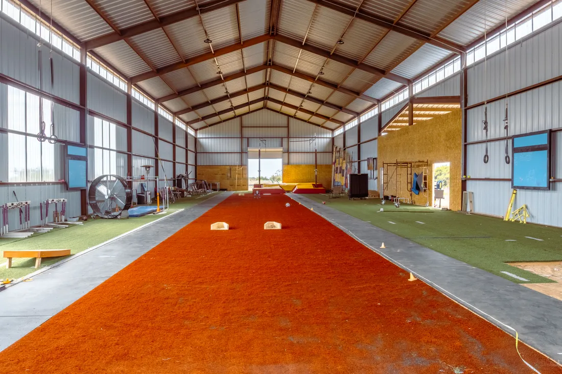 Looking down the full indoor runway toward the pit