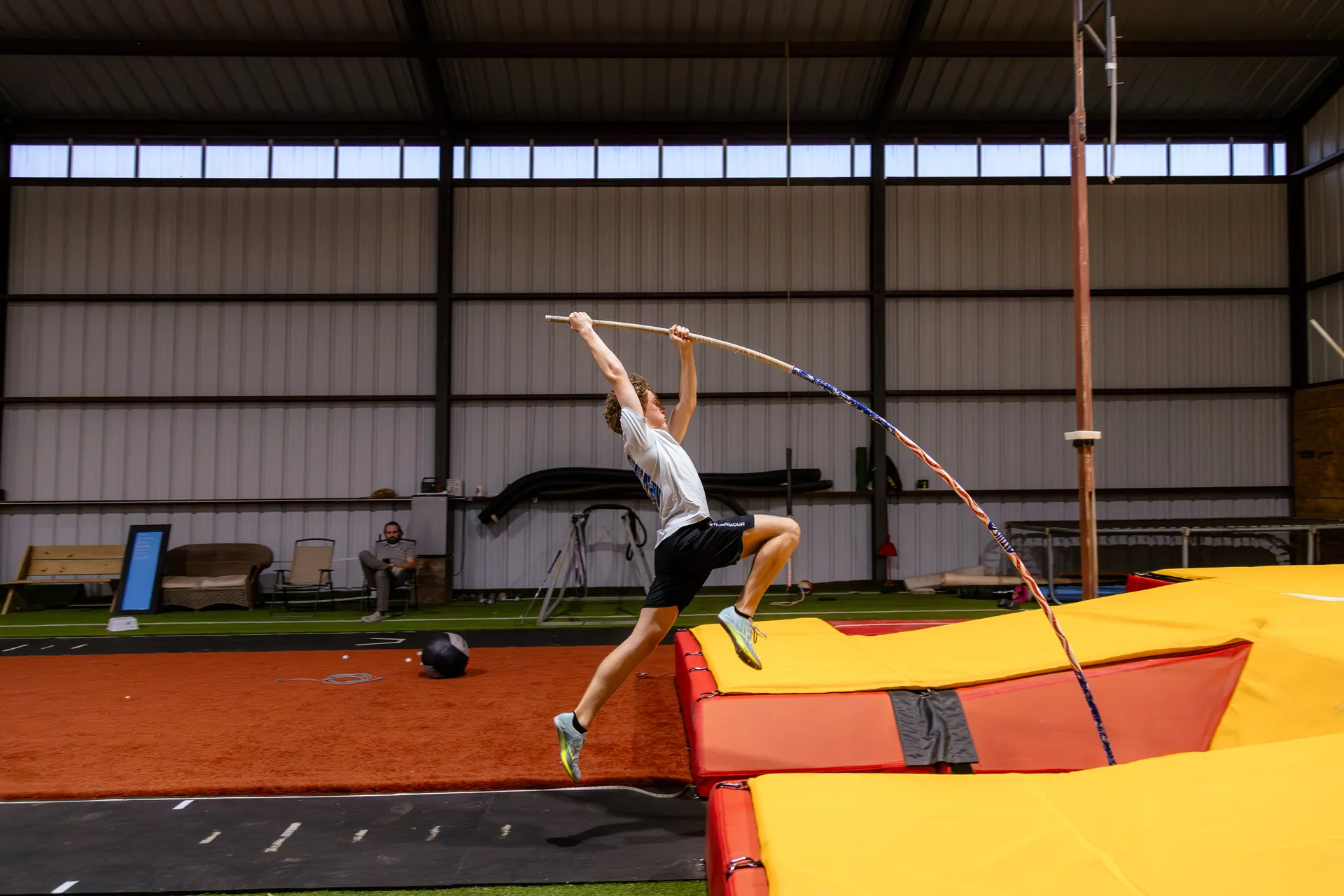 Vaulter planting into the pit at Off The Grid Pole Vault